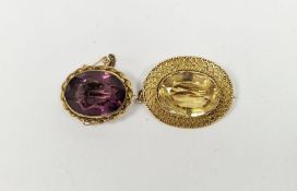 Gold-coloured metal and citrine set brooch, the oval cut stone with filigree border and an