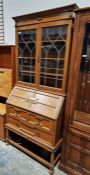 A early 20th century oak bureau bookcase, the top section having two leaded glass glazed doors