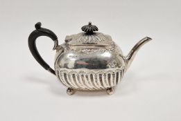 Late Victorian silver teapot, with wooden handle and knob to lid, half gadrooned body on four bun