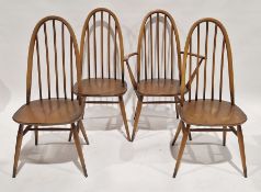 Set of four Ercol-style dining chairs comprising three standard and one carver with spindle backs,