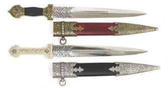 Matched pair of Persian-style daggers, each with chased blade and having scabbard with embossed