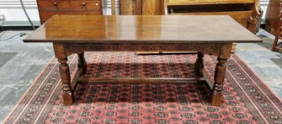 Reproduction oak refectory-style dining table with foliate carved lunette frieze, on bulbous