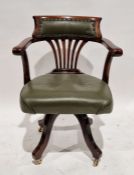 Shoolbred and Co mahogany captain's swivel armchair with a leather upholstered back and seat on