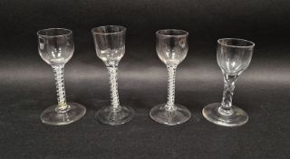 Four 18th century drinking glasses, including: two with opaque twist and gauze stems, another with