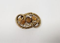 Victorian gold-coloured metal and citrine set brooch of interwoven scrolls and set three stones