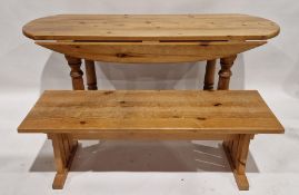Modern pine drop-leaf dining table of oval form, 77cm high x 166cm wide x 62cm deep when folded