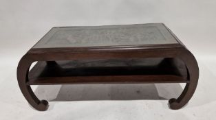 Chinese hardwood and glass-topped coffee table, the rectangular top carved with a scene of figures