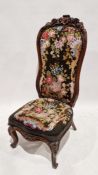 19th century rosewood framed high-back bedroom chair with carved floral motifs throughout and floral