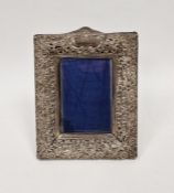 Late Victorian silver photograph frame, with pierced rocaille and floral frame centred by a scroll