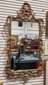 Large 19th century giltwood framed wall hanging mirror of rectangular form, decorated throughout
