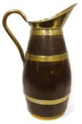 Brass-bound oak jug, floor standing, with brass lip and handle, 71cm high