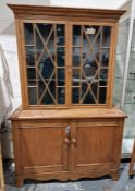Pine display cabinet, the glazed top with shaped shelves, cupboard below, on bracket feet, 120cm