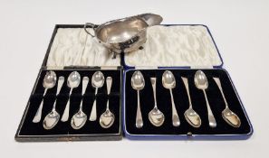 Early 20th century silver sauce boat with scroll handle, scroll inverted rim on three pad feet,