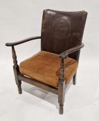 20th century leather-back armchair with masted ship motif to the back, on turned front legs, 78cm