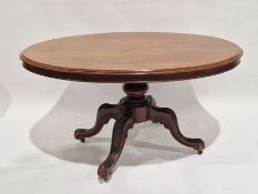 Victorian mahogany tilt-top dining table of oval form, with turned pillar support, on four