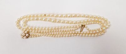 Double string of graduated cultured pearls on 9ct gold pearl set clasp.