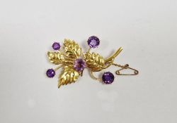 Gold coloured metal and amethyst coloured stone foliate spray brooch, set five amethyst coloured