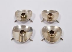 Set of four mid century Danish silver-plated candle holders, each raised on three feet, 2cm high (4)