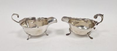 Revived Georgian style sauce boat having open double 'C' scroll handle ,oval and raised on three