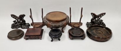 Group of Asian and European carved wood display stands, including a pair formed from flowering