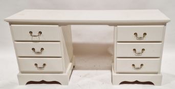 White painted pine desk, each pedestal having three short drawers with metal handles, raised on