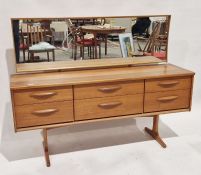 Austinsuite teak dressing table, with long hinged mirror back over six drawers, each with curved