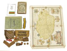 WWII medal in glazed case, sundry arm badges and ribbons, a Philips old card map of England stamp