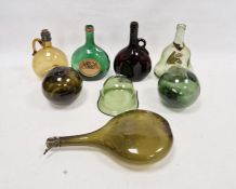 Five 19th/early 20th century green and straw tinted glass bottles, two green tinted witches balls