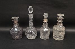 Four early-mid 19th century cut-glass decanters and stoppers, variously cut with stars, diamonds and