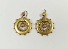 Pair of Victorian gold coloured metal pendant drop earrings in the form of circular ship's wheel