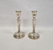 Pair of tapering silver candlesticks, on reeded domed feet, hallmarked Birmingham 2003, maker's