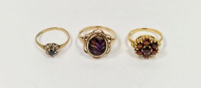 9ct gold and garnet cluster dress ring, a 9ct gold and bluejohn oval ring and a 9ct gold, sapphire