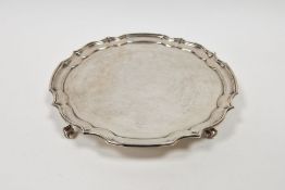 Silver salver in Georgian-style, having raised Chippendale border and on four scroll feet,