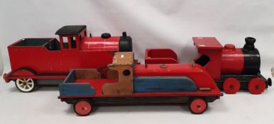 Three large painted wooden locomotives to include a red and blue locomotive a red and black