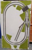Large railway layout containing double circuit with fake grass on wooden base, 176cm x 107cm x 6cm