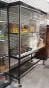 Modern glass display cabinet on stand.