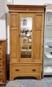 Edwardian satin walnut single wardrobe with bevelled mirror panelled door over a drawer to base,