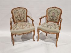 Pair of reproduction French-style open arm elbow chairs with tapestry woolwork upholstered pad backs