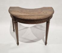 Late 19th century oak demi lune table with acanthus carved border, with concave side, having an