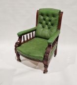 Edwardian mahogony green and leather upholstered elbow chair, the arms supported on turned