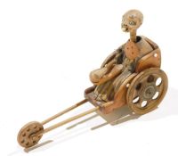 Kobe-Ningyo carved boxwood figure of a Buddhist monk in a cart, early 20th century, with working