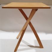 Modern light wood tripod table.