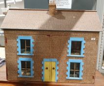 20th century painted board and paper covered doll's house with pair of panel doors to the front,