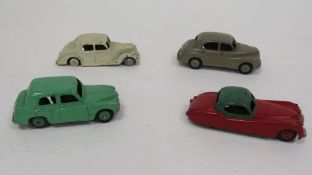 Four Dinky Toys Diecast model cars to include 157 Jaguar XK120 Coupe  red including ridged hubs with