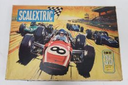 1960's Scalextric set, Team Set 35, with two cars, boxed, a controller and a catalogue, limited