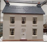 Cream painted wood doll's house in Georgian style and having lace curtains, together with a large