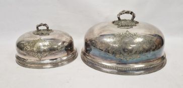 Two graduated 19th century silver-plated meat domes, each having scrolling engraved foliate motifs