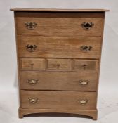 Mid 20th century oak chest of drawers with an arrangement of four long drawers and three short