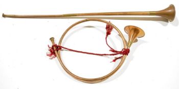 Two copper and brass-mounted hunting horns, first stamped 'Made in England', 90.5cm log, second of