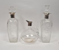 Pair of Edwardian cut glass and silver-mounted decanters, one with decoration depicting Scottish